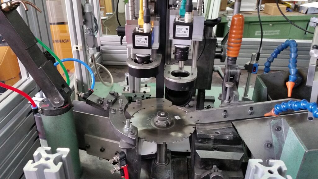 Retrofitted sorting machine with modern camera stations and telecentric lenses mounted on a metal disc inspection platform